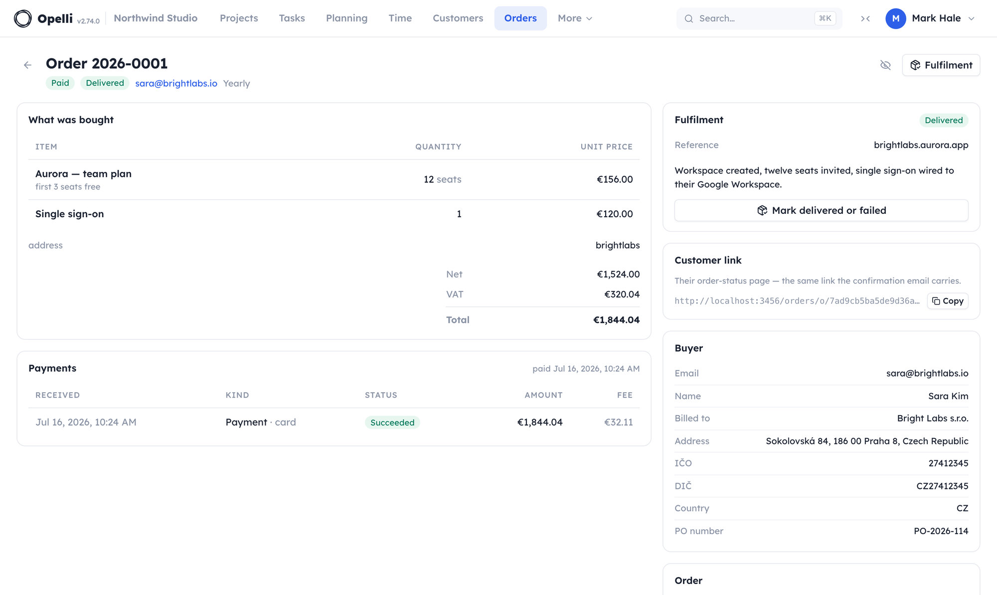 One paid order opened as a page: the lines and frozen totals, the address the buyer chose, the card payment with its fee, and the fulfilment recorded beside the billing details.